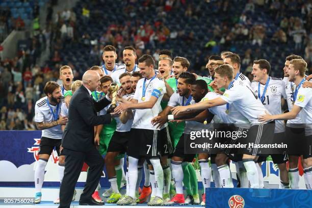 Gianni Infantino, FIFA president hands Julian Draxler of Germany the trophy after the FIFA Confederations Cup Russia 2017 Final between Chile and...