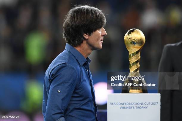 Germany's coach Joachim Loew walks past the winner's trophy during the award ceremony after Germany beat Chile 1-0 in the 2017 Confederations Cup...