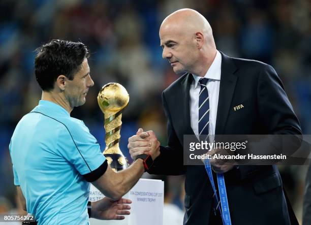 Referee Milorad Mazic shakes hands with Gianni Infantino, FIFA president emrbace after the FIFA Confederations Cup Russia 2017 Final between Chile...