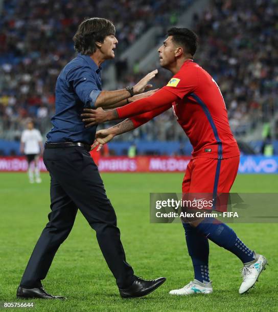 Joachim Loew, coach of Germany and Gonzalo Jara of Chile argue during the FIFA Confederations Cup Russia 2017 Final between Chile and Germany at...