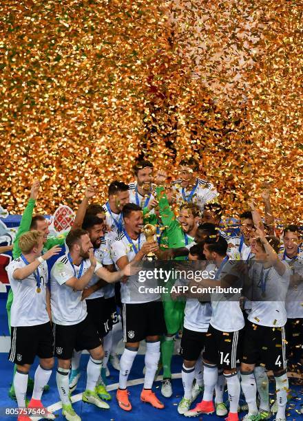 Germany's players pose with the trophy after winning the 2017 Confederations Cup final football match between Chile and Germany at the Saint...