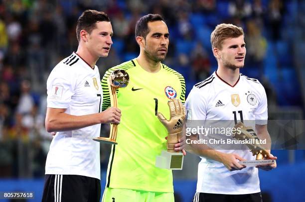 Julian Draxler, Claudio Bravo and Timo Werner pose with their individual trophies following the FIFA Confederations Cup Russia 2017 Final match...