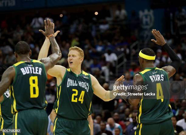Brian Scalabrine high fives teammates Rasual Butler and Derrick Byars of the Ball Hogs during week two of the BIG3 three on three basketball league...