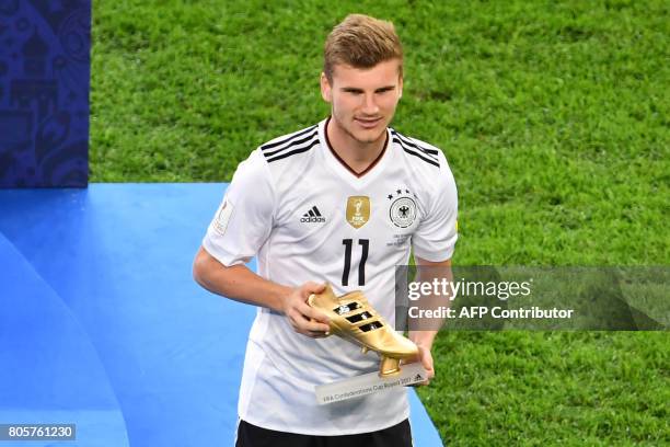 Germany's forward Timo Werner holds up the Golden Boot for best scorer after Germany beat Chile 1-0 in the 2017 Confederations Cup final football...