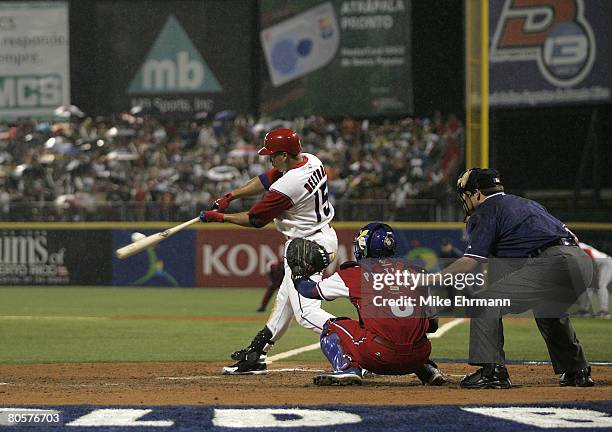 Carlos Beltran of team Puerto Rico hits an RBI single during a 2nd round game against team Cuba during the 2006 World Baseball Classic at Hiram...