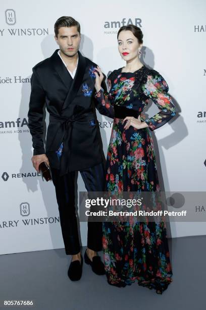 Ulyana Sergeenko and guest attend the amfAR Paris Dinner 2017 at Le Petit Palais on July 2, 2017 in Paris, France.