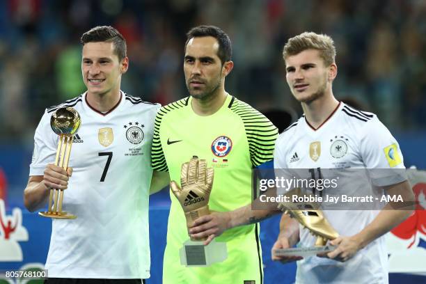 Timo Werner of Germany poses with the golden boot, Julian Draxler of Germany the golden ball and Claudio Bravo of Chile the golden glove at the end...