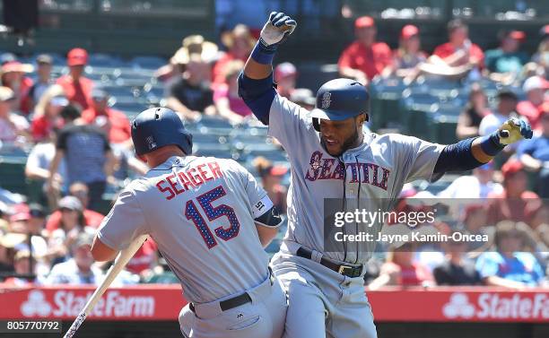 Robinson Cano of the Seattle Mariners celebrates with Kyle Seager of the Seattle Mariners after hitting a three run home run in the eighth inning of...