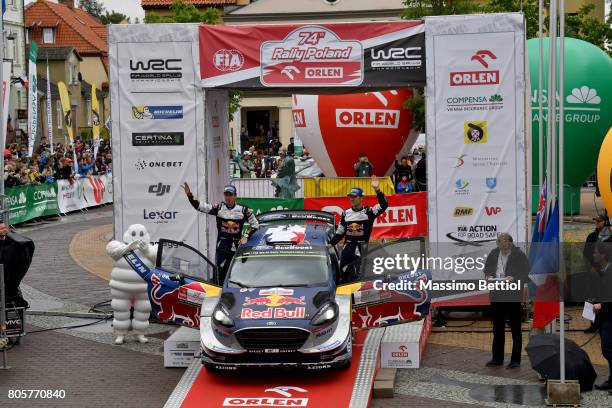 Sebastien Ogier of France and Julien Ingrassia of France celebrate their third position in the final overall during Day Three of the WRC Poland on...