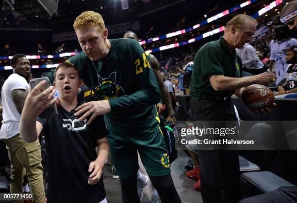 Brian Scalabrine of Ball Hogs poses for a photo with a young fan after a win over Tri-State during week two of the BIG3 three on three basketball...