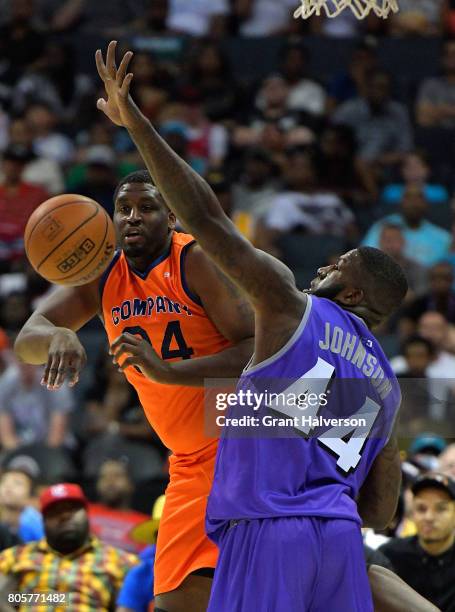 Michael Sweetney of 3's Company makes a pass around Ivan Johnson of Ghost Ballers during week two of the BIG3 three on three basketball league at...