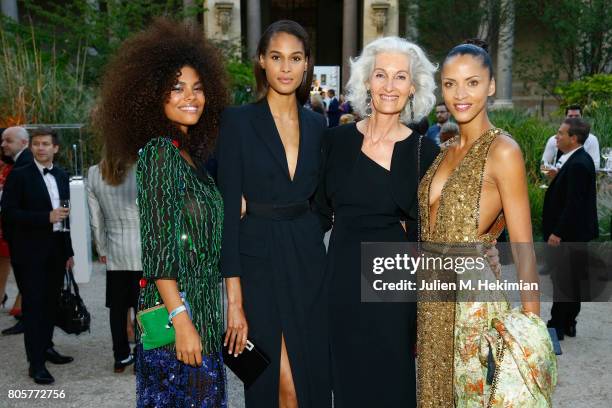 Tina Kunakey, Cindy Bruna, Catherine Loewe Noemie Lenoir attends the amfAR Paris Dinner 2017 at Le Petit Palais on July 2, 2017 in Paris, France.