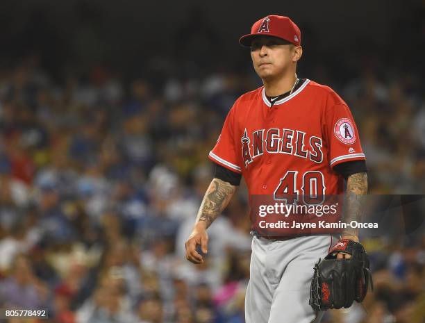 Jesse Chavez of the Los Angeles Angels of Anaheim walks to the dugout after he was pulled in the sixth inning of the game against the Los Angeles...