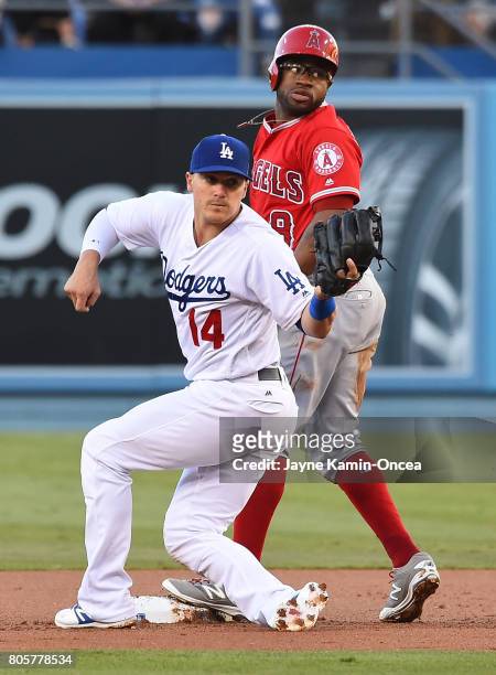 Enrique Hernandez of the Los Angeles Dodgers waits for the call after tagging Eric Young Jr. #8 of the Los Angeles Angels of Anaheim out on an...
