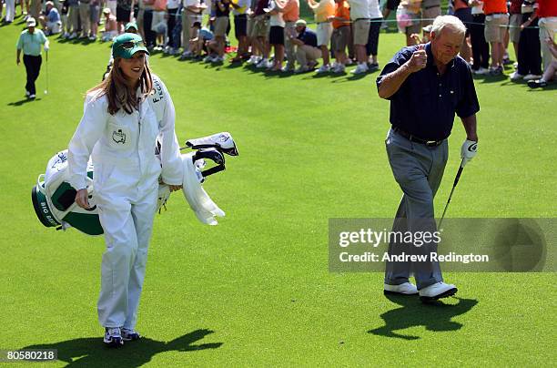 Kelly Tilghman from The Golf Channel caddies for Arnold Palmer during the Par 3 Contest prior to the start of the 2008 Masters Tournament at Augusta...