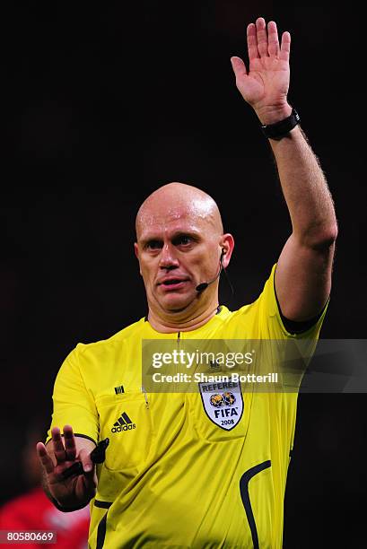 Referee Tom Henning Ovrebo gestures during the UEFA Champions League Quarter Final 2nd leg match between Manchester United and AS Roma at Old...