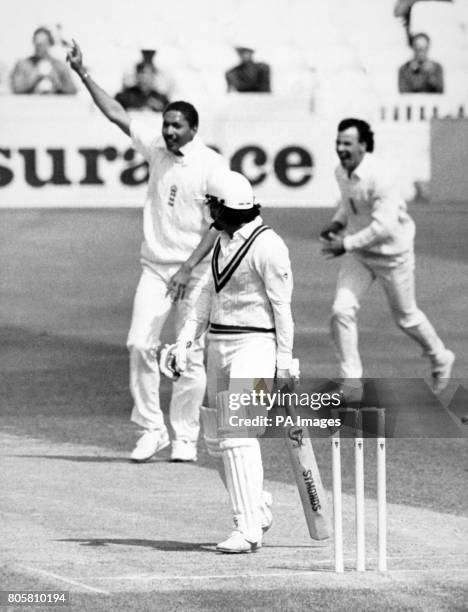 Pakistan batsman Ramiz Raja walks back to the Pavilion as England bowler Phil DeFreitas holds up his hand and John Emburey runs to celebrate