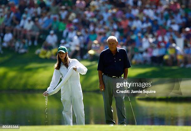 Kelly Tilghman from The Golf Channel caddies for Arnold Palmer during the Par 3 Contest prior to the start of the 2008 Masters Tournament at Augusta...