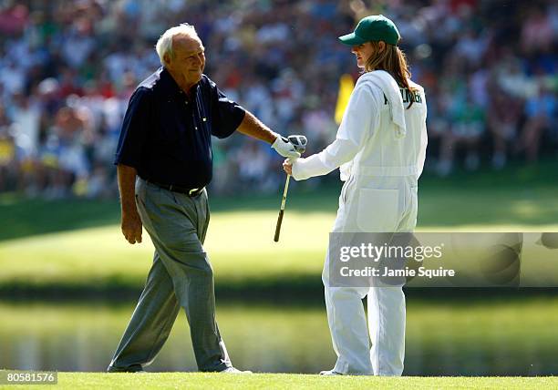 Kelly Tilghman from The Golf Channel caddies for Arnold Palmer during the Par 3 Contest prior to the start of the 2008 Masters Tournament at Augusta...