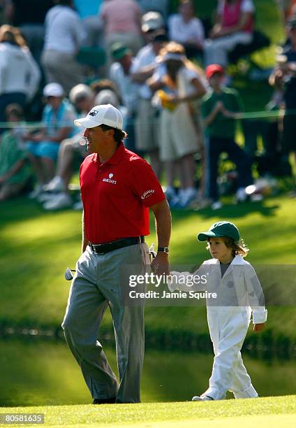 Phil Mickelson walks with his son Evan during the Par 3 Contest prior to the start of the 2008 Masters Tournament at Augusta National Golf Club on...