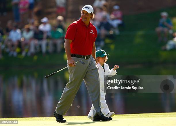 Phil Mickelson walks with his son Evan during the Par 3 Contest prior to the start of the 2008 Masters Tournament at Augusta National Golf Club on...