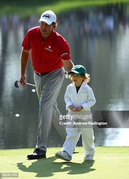 Phil Mickelson walks with his son Evan during the Par 3 Contest prior to the start of the 2008 Masters Tournament at Augusta National Golf Club on...