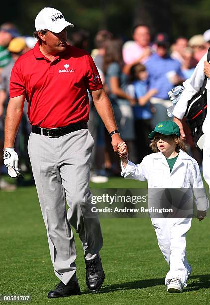 Phil Mickelson walks with his son Evan during the Par 3 Contest prior to the start of the 2008 Masters Tournament at Augusta National Golf Club on...