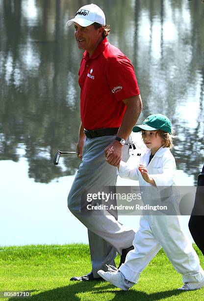 Phil Mickelson walks with his son Evan during the Par 3 Contest prior to the start of the 2008 Masters Tournament at Augusta National Golf Club on...