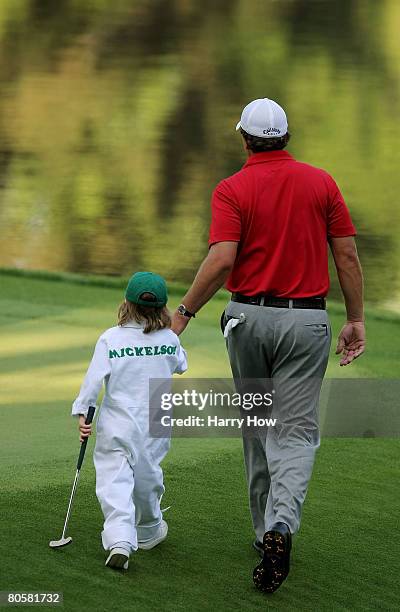 Phil Mickelson walks with his son Evan during the Par 3 Contest prior to the start of the 2008 Masters Tournament at Augusta National Golf Club on...