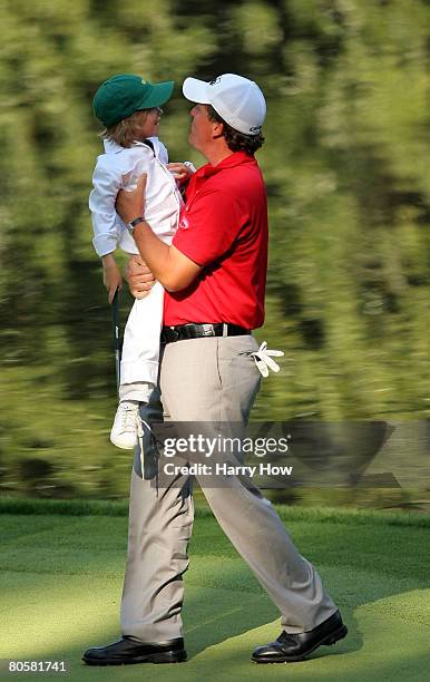 Phil Mickelson walks with his son Evan during the Par 3 Contest prior to the start of the 2008 Masters Tournament at Augusta National Golf Club on...