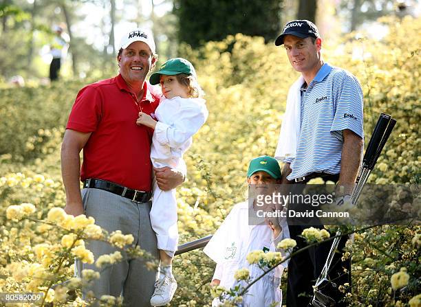 Phil Mickelson holds his son Evan and Jim Furyk stands with his daugher Caleigh Lynn during the Par 3 Contest prior to the start of the 2008 Masters...