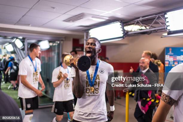 Antonio Ruediger of Germany holds the trophy and celebrate with team mates in the players tunnel after winning the FIFA Confederations Cup final...