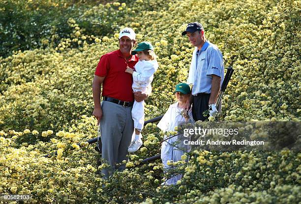 Phil Mickelson holds his son Evan and Jim Furyk stands with his daugher Caleigh Lynn during the Par 3 Contest prior to the start of the 2008 Masters...