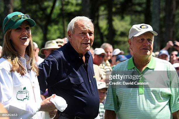 Kelly Tilghman from The Golf Channel caddies for Arnold Palmer as Jack Nicklaus looks on during the Par 3 Contest prior to the start of the 2008...