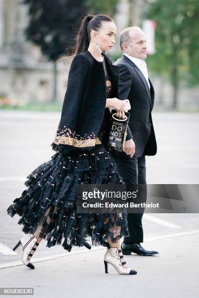 Guest wears a black lace dress, outside the amfAR dinner at Petit Palais, during Paris Fashion Week - Haute Couture Fall/Winter 2017-2018, on July 2,...