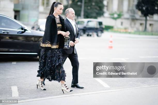 Guest wears a black lace dress, outside the amfAR dinner at Petit Palais, during Paris Fashion Week - Haute Couture Fall/Winter 2017-2018, on July 2,...