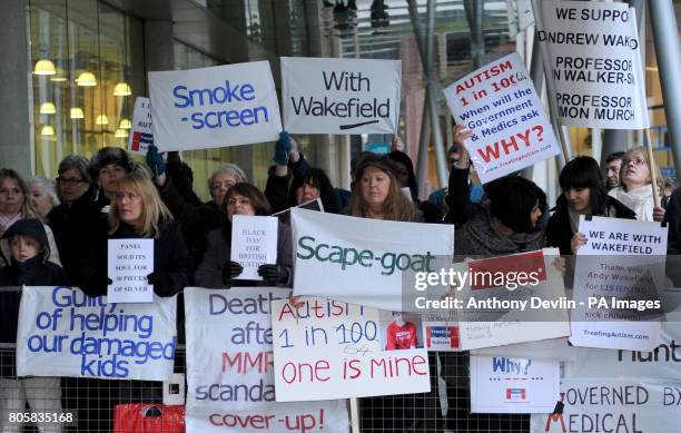 Demonstrators show their support for MMR research doctor Andrew Wakefield before he makes statement at the General Medical Council headquarters in...