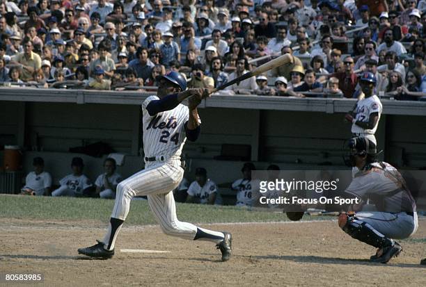 S: Outfielder Willie Mays of the New York Mets swings and watches the flight of his ball against the San Francisco Giants during a circa early 1970's...