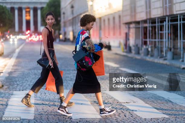 Models with shopping bags outside Miu Miu Cruise Collection during Paris Fashion Week - Haute Couture Fall/Winter 2017-2018 : Day One on July 2, 2017...