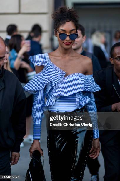 Model Jourdan Dunn wearing a ripped off shoulder top, PVC skirt outside Miu Miu Cruise Collection during Paris Fashion Week - Haute Couture...