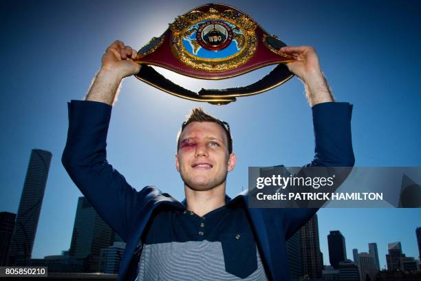 Newly crowned World Boxing Organization welterweight champion Jeff Horn of Australia poses for photographs with his belt during a press conference in...