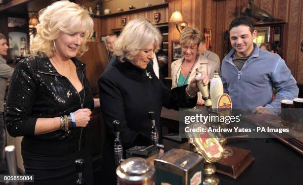 The Duchess of Cornwall pulls a pint of beer as she meets actors Beverley Callard, who plays landlady Liz McDonald , Anne Kirkbride, who plays the...