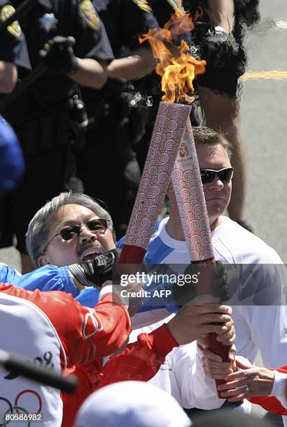 Olympic torch runner Ed Lee smiles before running with the Olympic torch in San Francisco, April 9, 2008. Hundreds of baton-wielding police herded...