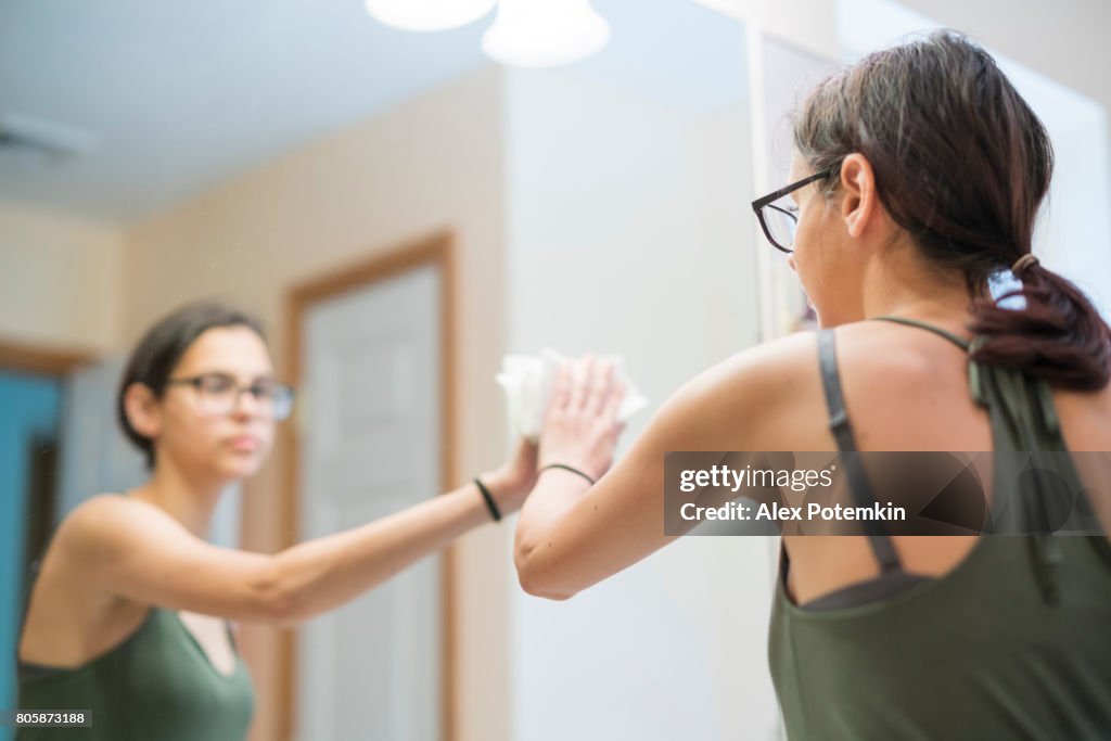 15-years-old teenager girl cleaning the domestic bathroom.