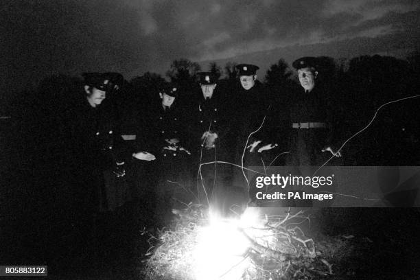 Police warm themselves by a bonfire at Monasterevin this evening as the Herrama kidnap siege enters yet another long, cold night.