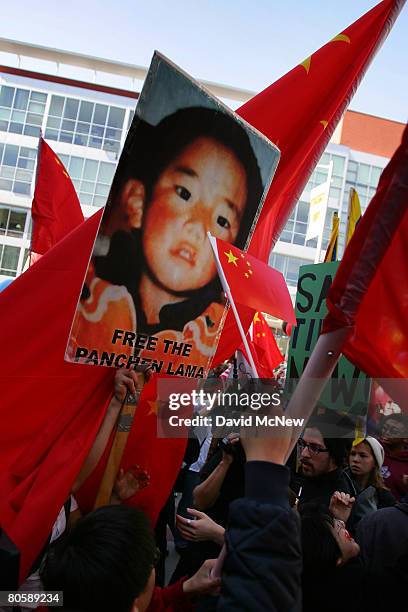 Protesters hold a picture of the Panchen Lama as China protesters and supporters face off while waiting for the Olympic torch to pass on April 9,...