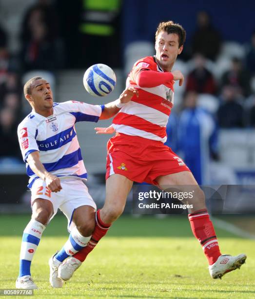 Queens Park Rangers' Jay Simpson and Doncaster Rovers' Elliott Ward during the Coca-Cola Championship match at Loftus Road, London.