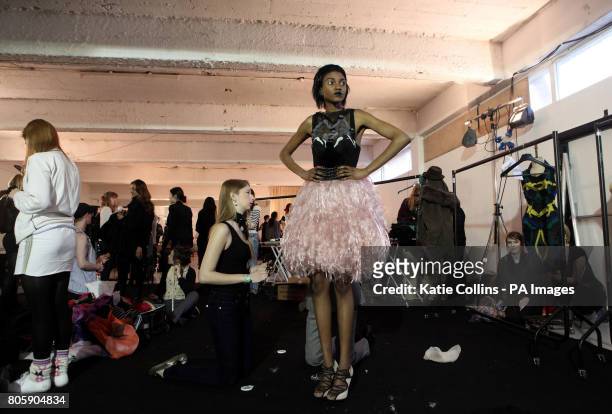 Model has her dress altered backstage at the Nathan Jenden - a/w 2010 catwalk show at The Dairy, London.