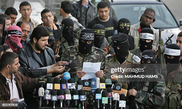 Palestinian militants from Islamic Jihad, the Popular Resistance Committees , and the Mujahedeen hold a press conference in Gaza City on April 9,...