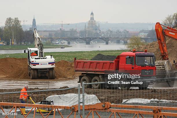 The Frauenkirche Cathedral and historical city center are visible behind the building site of the controversial Waldschloesschen Bridge on the Elbe...